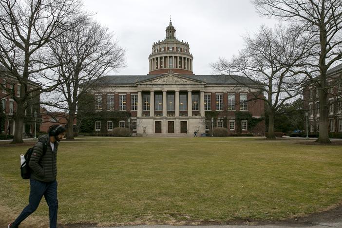 Students walk by the Rush Rhees Library at the University of Rochester on Feb. 22, 2023.