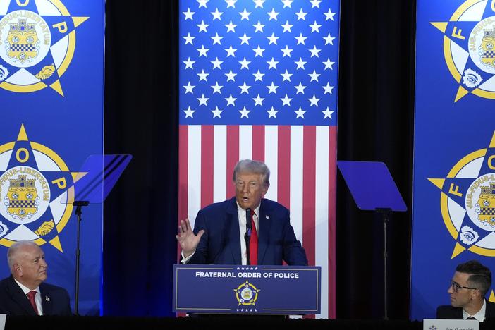 President-elect Donald Trump speaks to the National Fraternal Order of Police during the campaign, in Charlotte, N.C., as FOP president Patrick Yoes, left, and FOP vice president Joe Gamaldi listen.