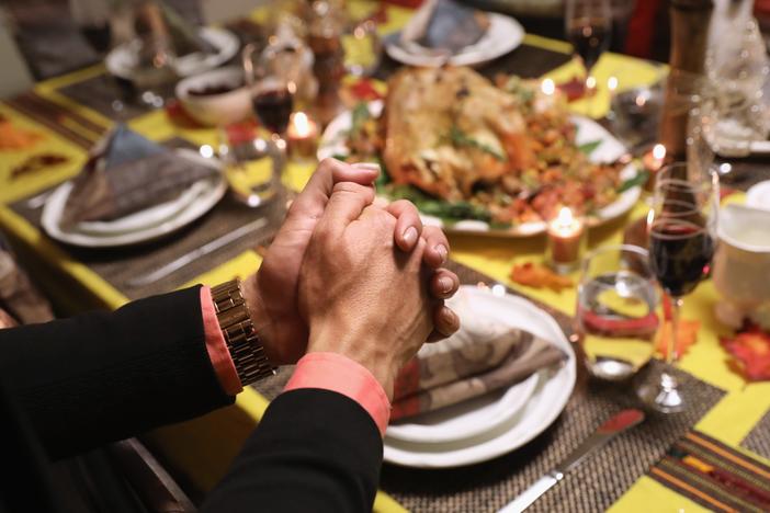 Central American immigrants and their families pray before Thanksgiving dinner on Nov. 24, 2016 in Stamford, Connecticut.