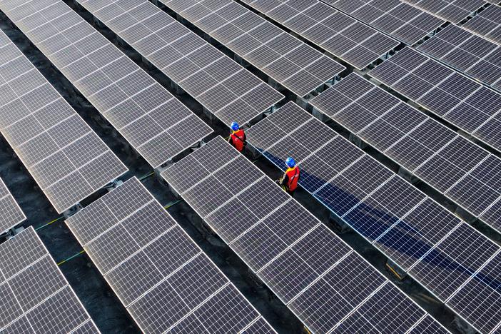 Renewable energy capacity is growing rapidly, especially in China, where this rooftop solar array is installed. The increasing use of sources like wind and solar power is driving down greenhouse gas emissions around the globe.