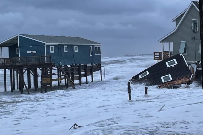 A portion of a house that collapsed during the overnight hours of Thursday and Friday is seen in the water in Rodanthe, N.C.