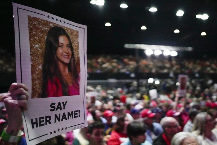 A supporter holds a sign with a photo of Laken Riley before former President Donald Trump speaks at a campaign rally on March 9 in Rome, Ga.