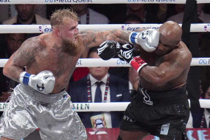 Jake Paul lands a left to Mike Tyson during their heavyweight boxing match on Friday in Arlington, Texas.
