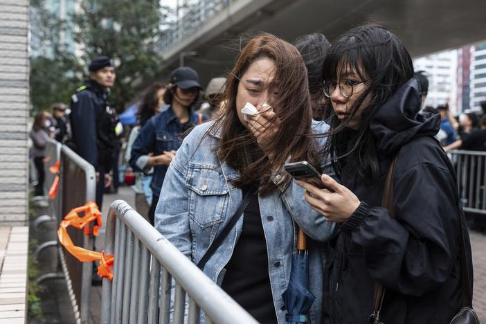 People leave the West Kowloon Magistrates' Courts in Hong Kong Tuesday, Nov. 19, 2024, following the sentencing in national security case.
