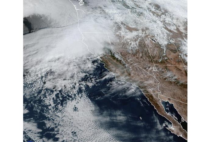 This satellite image Tuesday shows weather gathering in northern California and the Pacific Northwest.