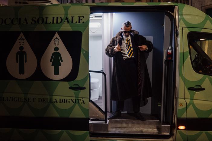 This man is stepping out from a van that offers showers and bathroom facilities to the homeless. Known for his elegant garb, he is one of the 2,000 or so people who live on the streets in Milan, Italy — the number comes from a city survey. An Italian charity called Alatha sponsors the "solidarity shower" van.