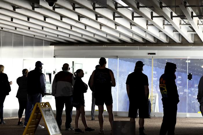 Voters wait in line to cast their ballots at Burton Barr Central Library before the polls open on Nov. 5 in Phoenix. President-elect Donald Trump won Arizona and the presidency, and he's on track to become the first Republican in two decades to win the national popular vote.