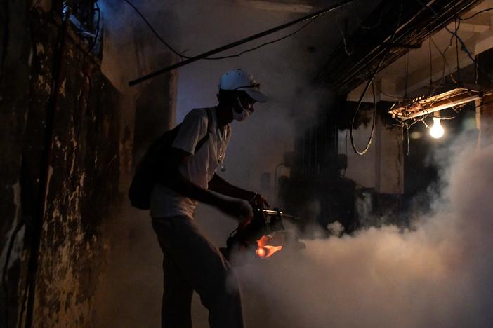 A health worker fumigates the basement of a building in Havana as Cuban health authorities launch small-scale efforts to fight the spread of the oropouche virus, which is transmitted by midge and mosquito bites.