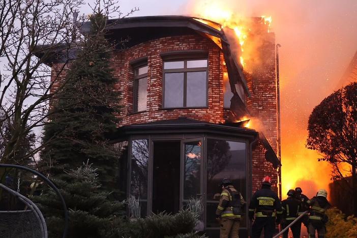 Emergency units carry out rescue tasks after a Russian attack on the city of Dnipro, in central Ukraine, on Thursday. Ukrainian officials are trying to determine whether Russian forces launched an intercontinental ballistic missile and other types of missiles.