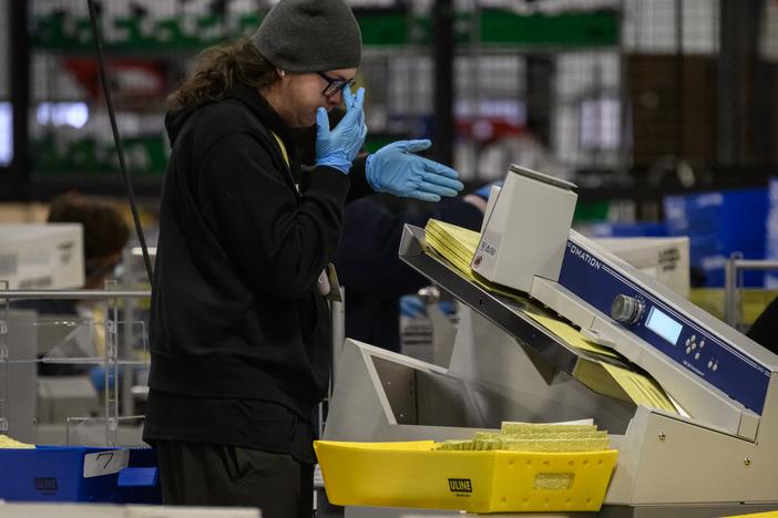A Philadelphia County elections staff member processes mail-in ballots on Election Day.