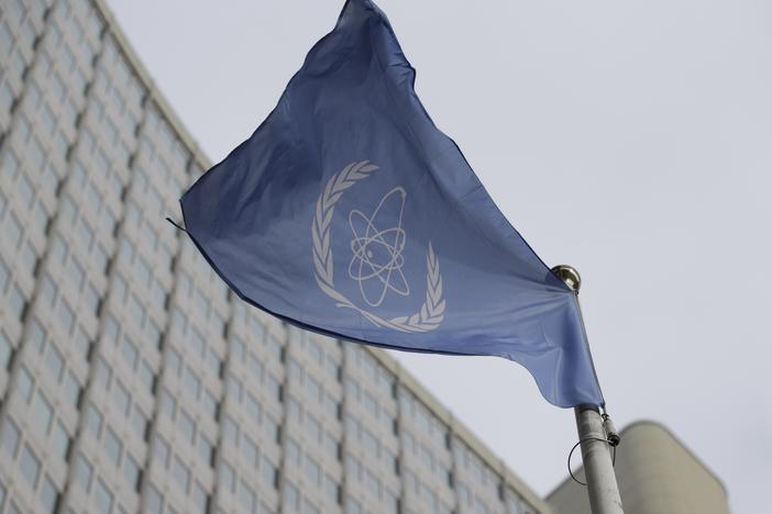 The flag of the International Atomic Energy Agency flies in front of its headquarters during an IAEA Board of Governors meeting in Vienna, Austria.