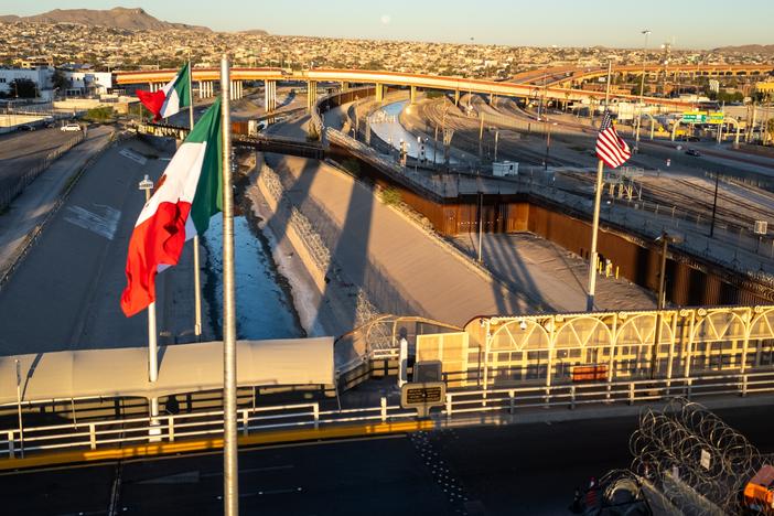 From an aerial view the Mexican and American flags fly over the Rio Grande at the U.S.-Mexico border in El Paso, Texas.