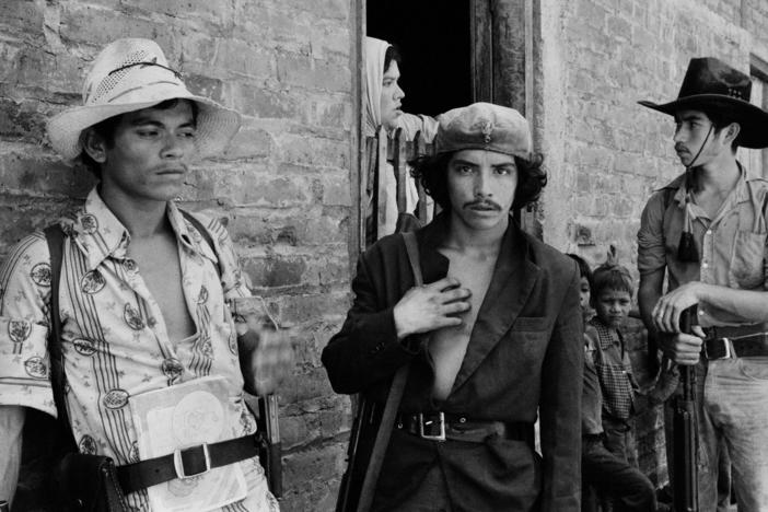 Guerrillas from the Ejército Revolucionario del Pueblo (ERP) speak with residents of San Agustín, Usulután department, on July 5, 1983.