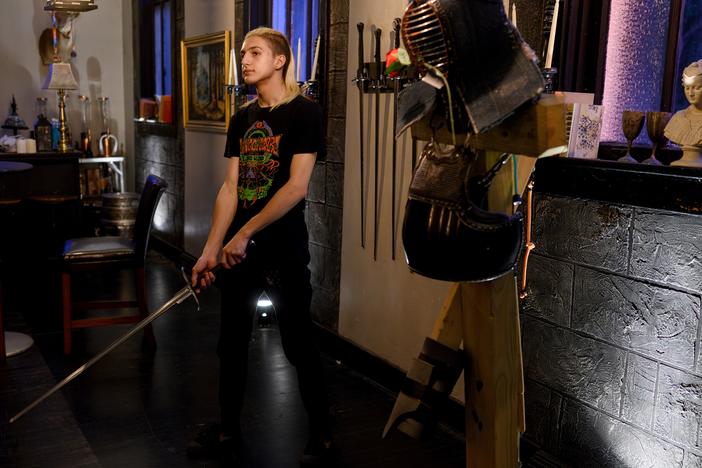 Gaia Ferrency, 17, of Swissvale, Pa., waits to participate in a long-sword tournament as part of Friday Night Fights, hosted by Pittsburgh Sword Fighters, on Oct. 4 at a former Catholic church northeast of Pittsburgh.