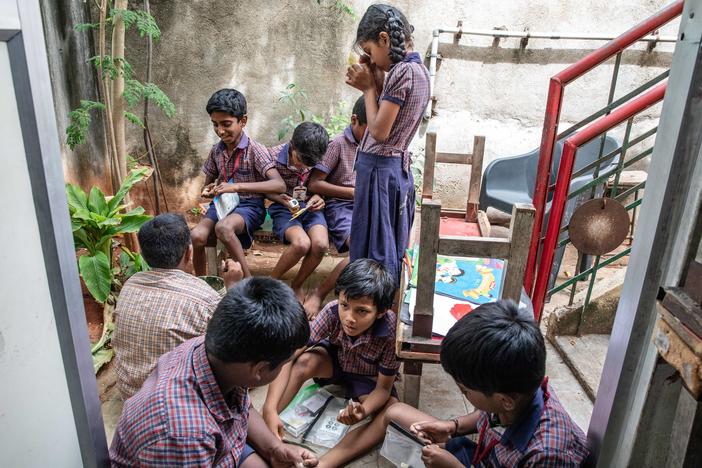 Students at Eden School in northern India prepare specimens they've collected to examine in the Foldscope. The paper microscope, invented a decade ago, is given for free for schools in lower resource countries, giving students a different perspective on specimens from ants to pollen.