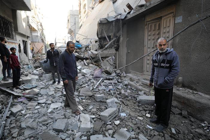 Palestinians inspect damage following an Israeli airstrike that hit a home in the north of Gaza City on Thursday.