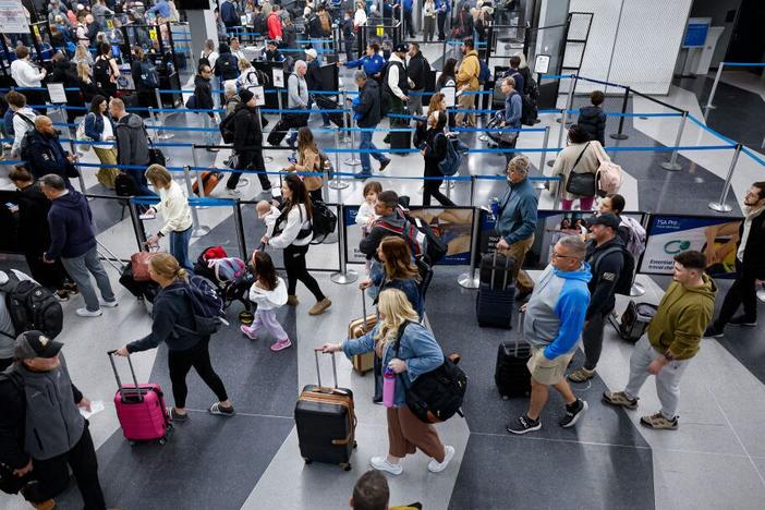 Travelers line up at the security checkpoint at O'Hare International Airport in Chicago on Friday ahead of the Thanksgiving holiday.