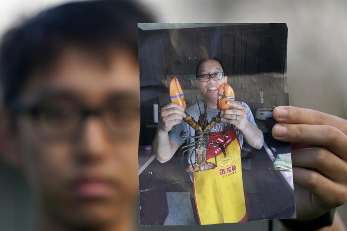 Harrison Li holds a photo of his father, Kai Li, on Jan. 23, 2024, in Palo Alto, California.