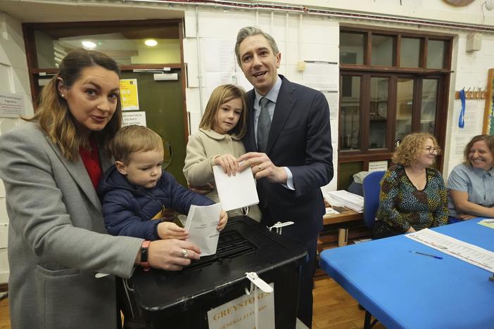 Irish Prime Minister and Fine Gael leader Simon Harris, center, accompanied by his wife Caoimhe and children Cillian and Saoirse, casts his vote at Delgany National School, County Wicklow, as voters go to the polls for the 2024 General Election in Ireland, on Friday.