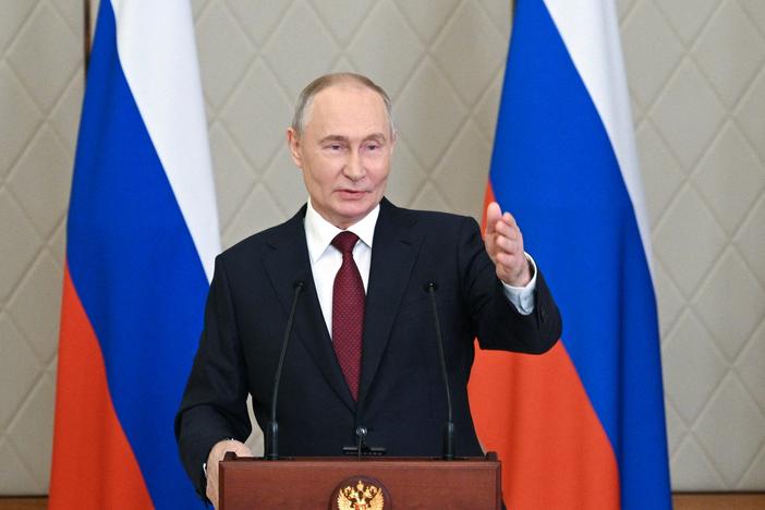 In this pool photograph distributed by the Russian state agency Sputnik, Vladimir Putin talks to the media after attending a meeting of the Collective Security Treaty Organization (CSTO) in Astana on Thursday.