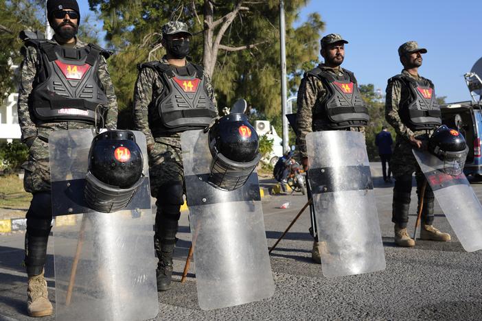Paramilitary soldiers stand guard along roadside to ensure security in Islamabad, Pakistan on Wednesday.