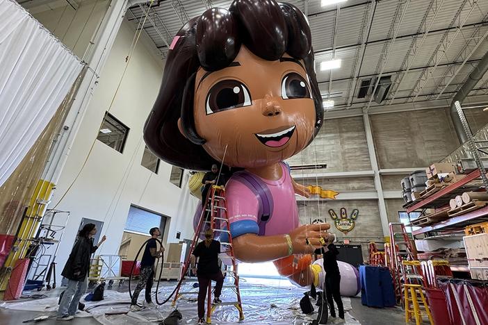 The Dora the Explorer balloon gets pumped up for a flight over the streets of New York City in the 98th Macy's Thanksgiving Day Parade.