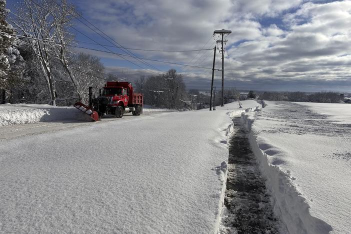 A snowplow on rounds in Lowville, N.Y., on Monday, Dec. 2, 2024. The region is cleaning up after feet of snow.