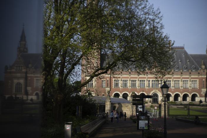 The Peace Palace housing the World Court, or International Court of Justice, is reflected in a monument in The Hague, Netherlands.