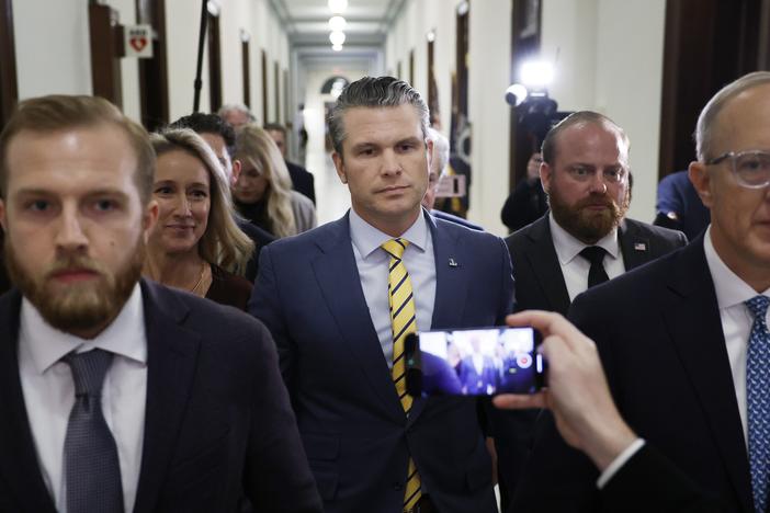Pete Hegseth, President-elect Donald Trump's nominee to be Secretary of Defense, and his wife Jennifer Rauchet walk through the Russell Senate Office building on Capitol Hill on Dec. 3, 2024.