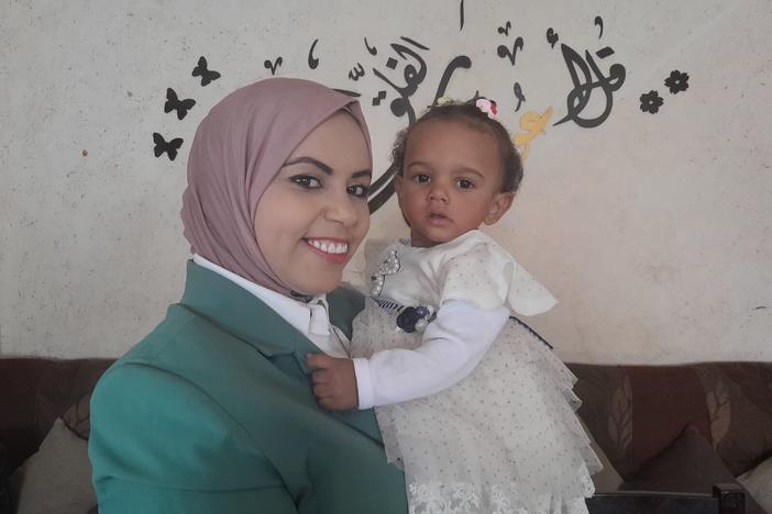 Amal Abu Khatleh, a nurse at a Gaza hospital that admitted an unidentified infant last November, took the baby in and gave her the name Malak, meaning angel. Abu Khatleh holds Malak on her first birthday in October, in Deir al-Balah, Gaza Strip.