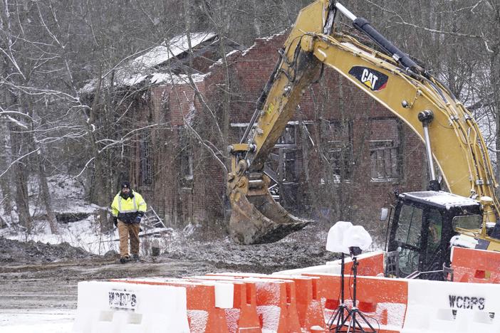 Rescue workers search on Thursday for Elizabeth Pollard, who is believed to have disappeared in a sinkhole while looking for her cat, in Marguerite, Pa.