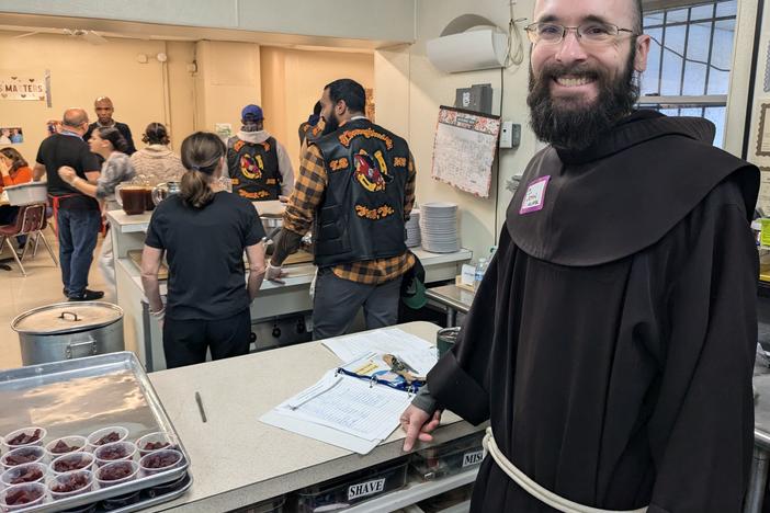 Brother John Neuffer of St Francis Ministries, with members of the Thoroughbreds Law Enforcement Motorcycle Club and other volunteers serving a Thanksgiving meal.