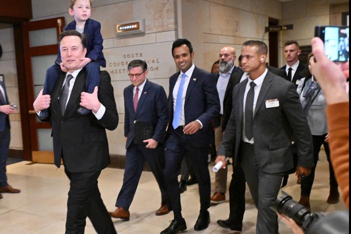 Tesla CEO Elon Musk (left), co-chair of the newly created Department of Government Efficiency (DOGE), carries his son "X" on his shoulders, as he walks with Speaker of the House Mike Johnson (second from left) and DOGE co-leader, businessman Vivek Ramaswamy (center), before a meeting with members of Congress at the Capitol on Dec 5.