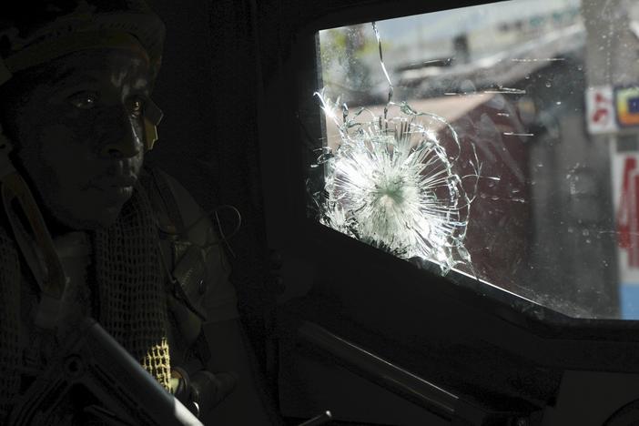 A Kenyan police officer, part of a U.N.-backed multinational force, patrols a street in Port-au-Prince, Haiti, on Dec. 5.