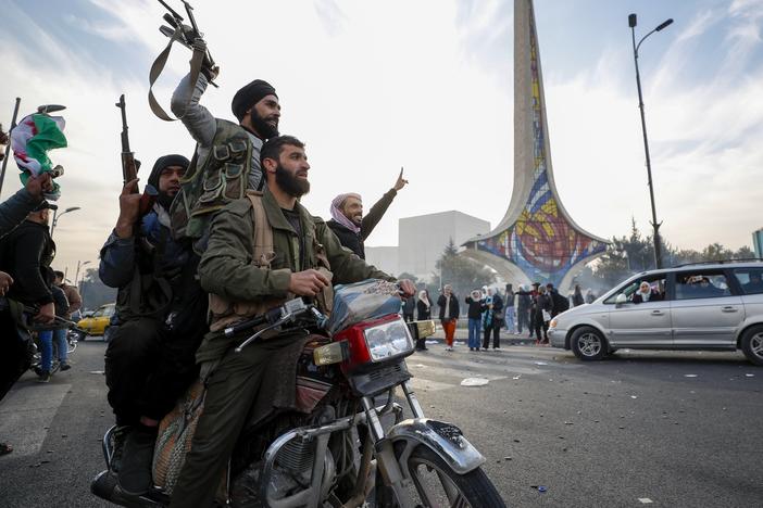 Syrian opposition fighters celebrate the fall of the Syrian government, in Damascus, Syria on December 8, 2024.
