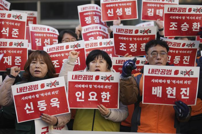 Members of the Korean Confederation of Trade Unions shout slogans as they hold signs carrying the names of the ruling party's lawmakers who didn't vote at the impeachment motion last week, during a rally in front of the ruling People Power Party's head office in Seoul, South Korea on Monday.