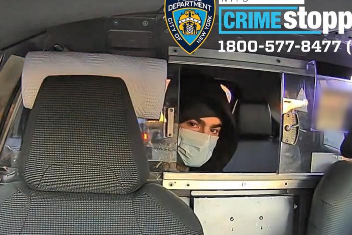 This undated photo released by the New York Police Department shows a suspect in the fatal shooting of UnitedHealthcare CEO Brian Thompson on Dec. 4, 2024, in a taxi. Part of the image was blurred by the source.