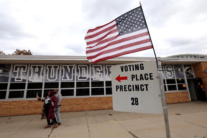 Voters take a selfie after casting ballots at Edsel Ford High School on Nov. 5 in Dearborn, Mich.