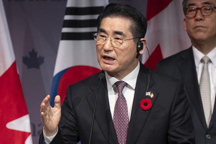 South Korean then-Defense Minister Kim Yong Hyun speaks during a news conference in Ottawa, Ontario, on Nov. 1, as  Foreign Minister Cho Tae-yul (right) looks on.