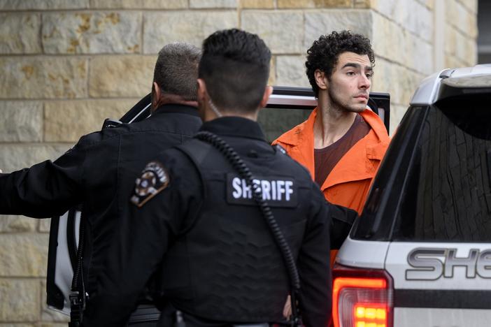 Suspected shooter Luigi Mangione is led into the Blair County Courthouse for an extradition hearing on Tuesday in Hollidaysburg, Pa.