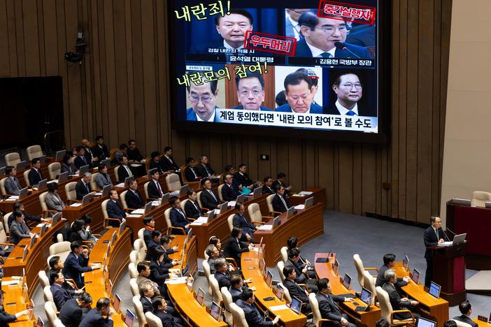 A screen displays photographs of South Korean President Yoon Suk Yeol (top left) and former and current cabinet ministers, accusing them of treason, during a plenary session at the National Assembly in Seoul, South Korea, on Wednesday. Yoon looks set to fight on rather than step down early as probes deepen into his martial law declaration and another likely impeachment bid loom.