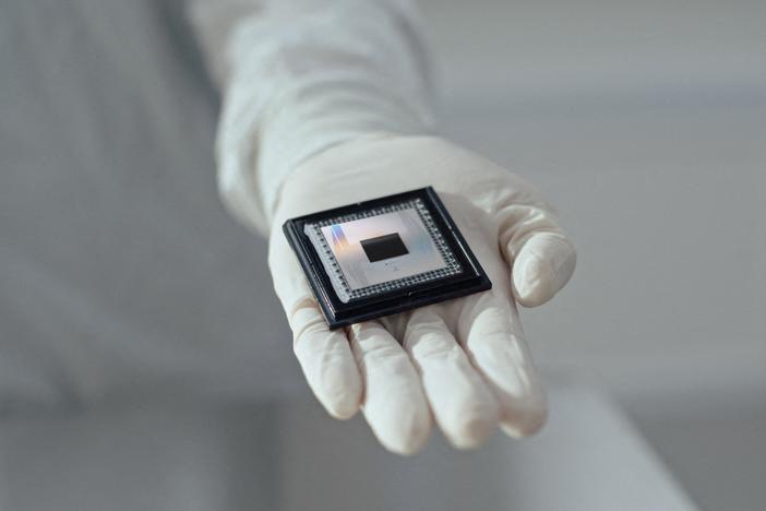 A person shows Google Quantum AI's "Willow" chip, in this undated handout photo obtained by Reuters on December 6, 2024.