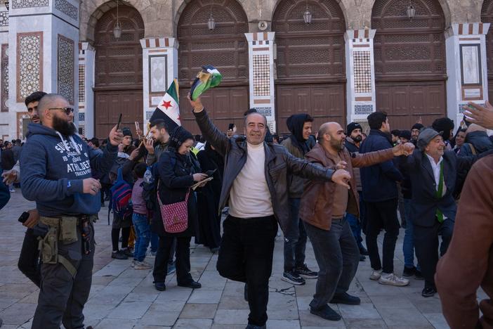 Men dance outside the Ummayad Mosque in Damascus, Syria, on Friday.