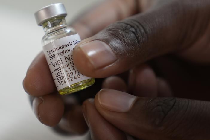A pharmacist holds a vial of lenacapavir, at the Desmond Tutu Health Foundation's Masiphumelele Research Site, in Cape Town, South Africa. The drug's development has been heralded as the 2024 Breakthrough of the Year by the journal <em>Science,</em> which described it as representing "a pivotal step toward diminishing HIV/AIDS as a global health crisis."