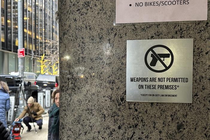 A no guns allowed sign is posted at the 54th Street entrance to the New York Hilton Midtown Hotel in New York, where Brian Thompson, the CEO of UnitedHealthcare, was fatally shot last week.