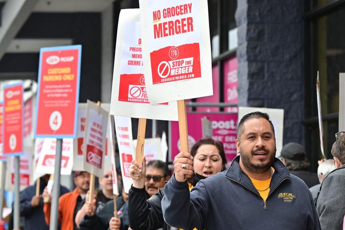 Unionized grocery store workers rally to oppose the proposed merger between Kroger and Albertsons outside a Ralph's supermarket in Los Angeles in 2023. On Wednesday, Albertsons said it was giving up on the deal after it was blocked by two courts.