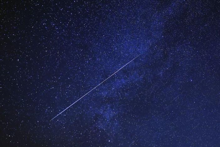 A meteor burns up in the sky over al-Abrak desert north of Kuwait City during the annual Geminid meteor shower early on Dec. 15, 2023.