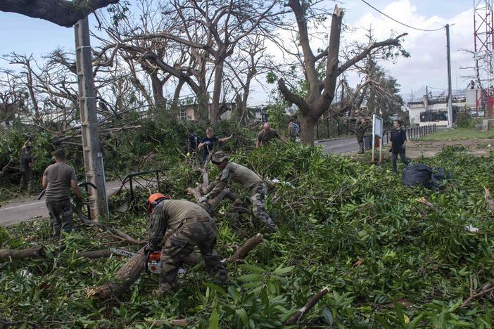 This photo provided Sunday Dec.15, 2024 by the French Army shows soldiers removing fallen trees in the French territory of Mayotte in the Indian Ocean, after Cyclone Chido caused extensive damage with reports of several fatalities.