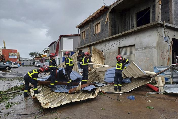 This photo provided Dec.15, 2024 by the Civil Security shows rescue workers clearing an area in the French territory of Mayotte in the Indian Ocean, after Cyclone Chido caused extensive damage with reports of several fatalities.