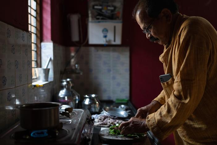 Shahu Patole prepares food in his mother's kitchen in Khamgaon, India. He's the author of the cookbook <em>Dalit Kitchens of Marathwada.</em>